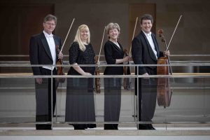 Pro Arte Quartet members stand by a railing