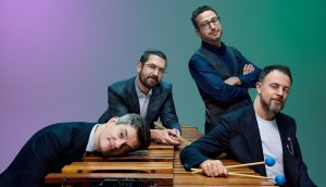 Members of Third Coast Percussion pose with marimbas
